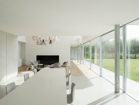 Dining table in a modern living room with a large window front